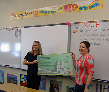 Angie Rajczyk presenting the check to Elizabeth