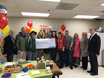 Paradise staff receiving the check