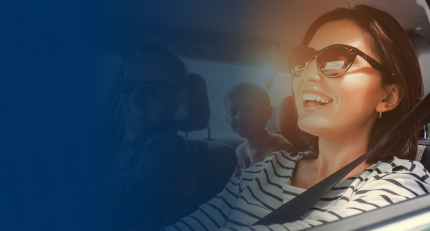 Happy family driving in a car on a sunny day