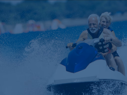 Mature couple riding on a jet ski watercraft