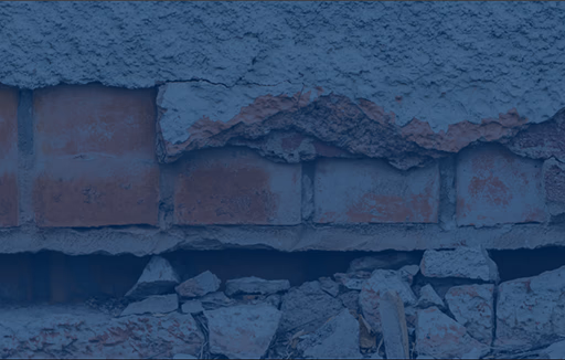 earthquake damaged stucco and brick exterior wall