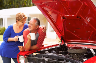 Couple enjoying spending time with their classic car