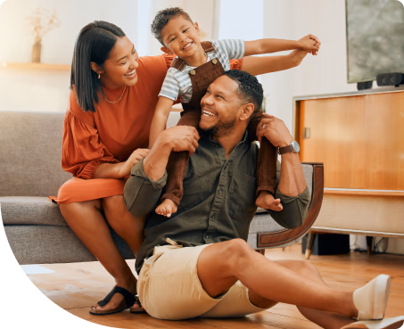 Young, happy family in living room laughing together