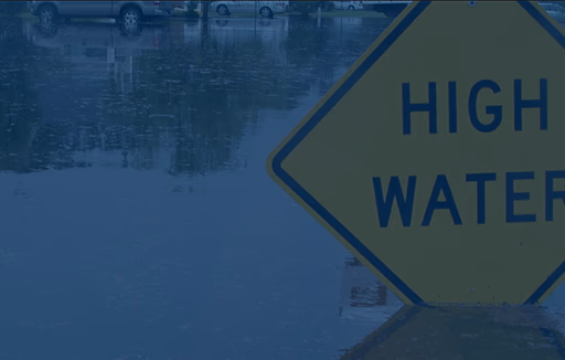 high water sign in flooded neighborhood