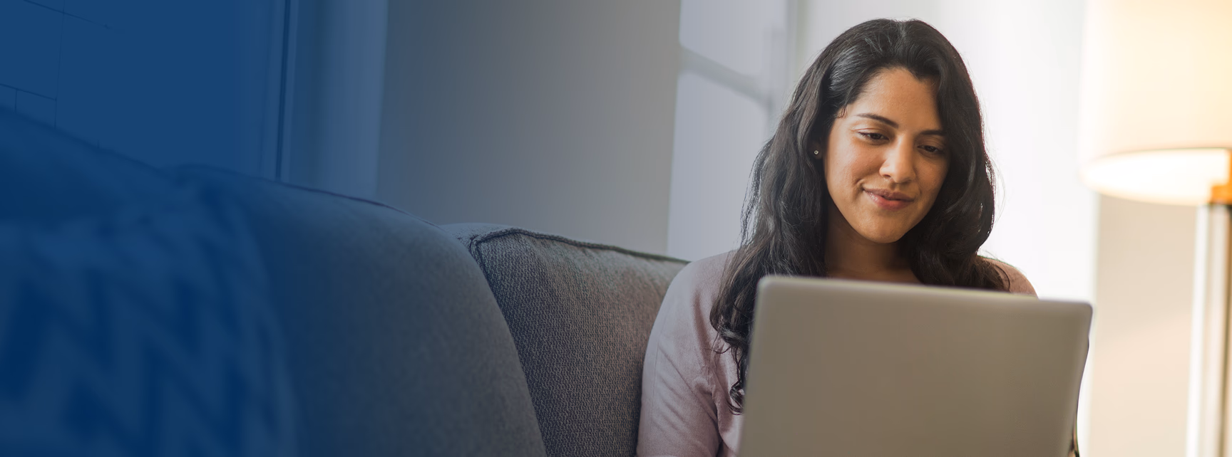 Woman on laptop looking through our contact us list.