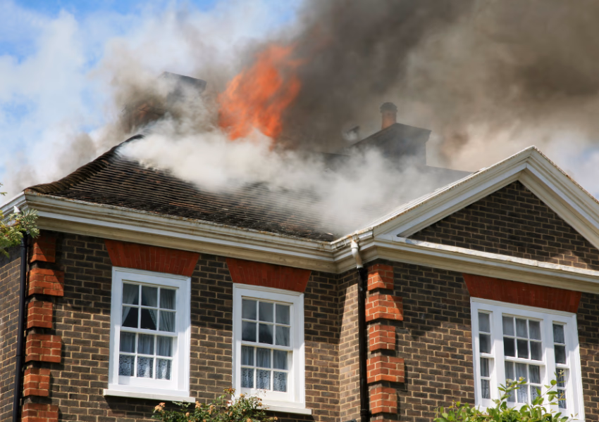 an image of a house with a fire on the roof