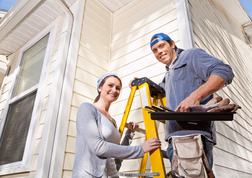 couple doing home maintenance outdoors