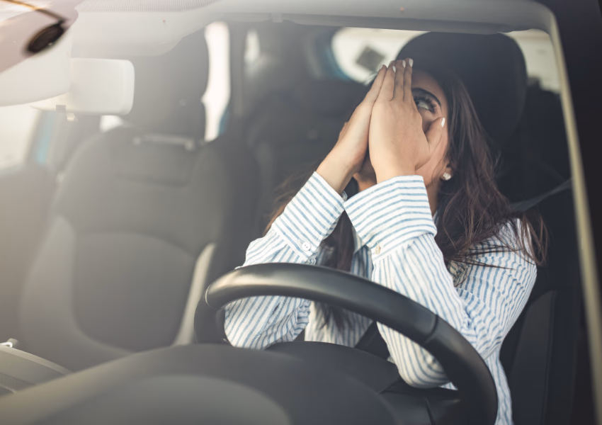 upset person sitting behind steering wheel