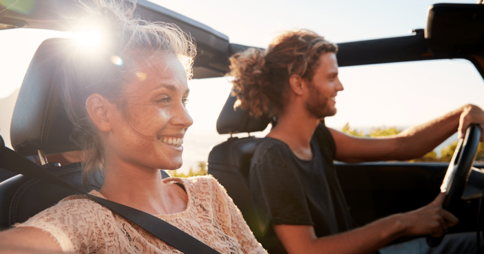 man driving with woman in passenger seat