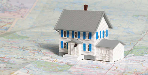 miniature house sitting on paper map