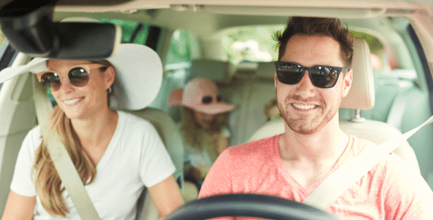 family in a vehicle with dad driving